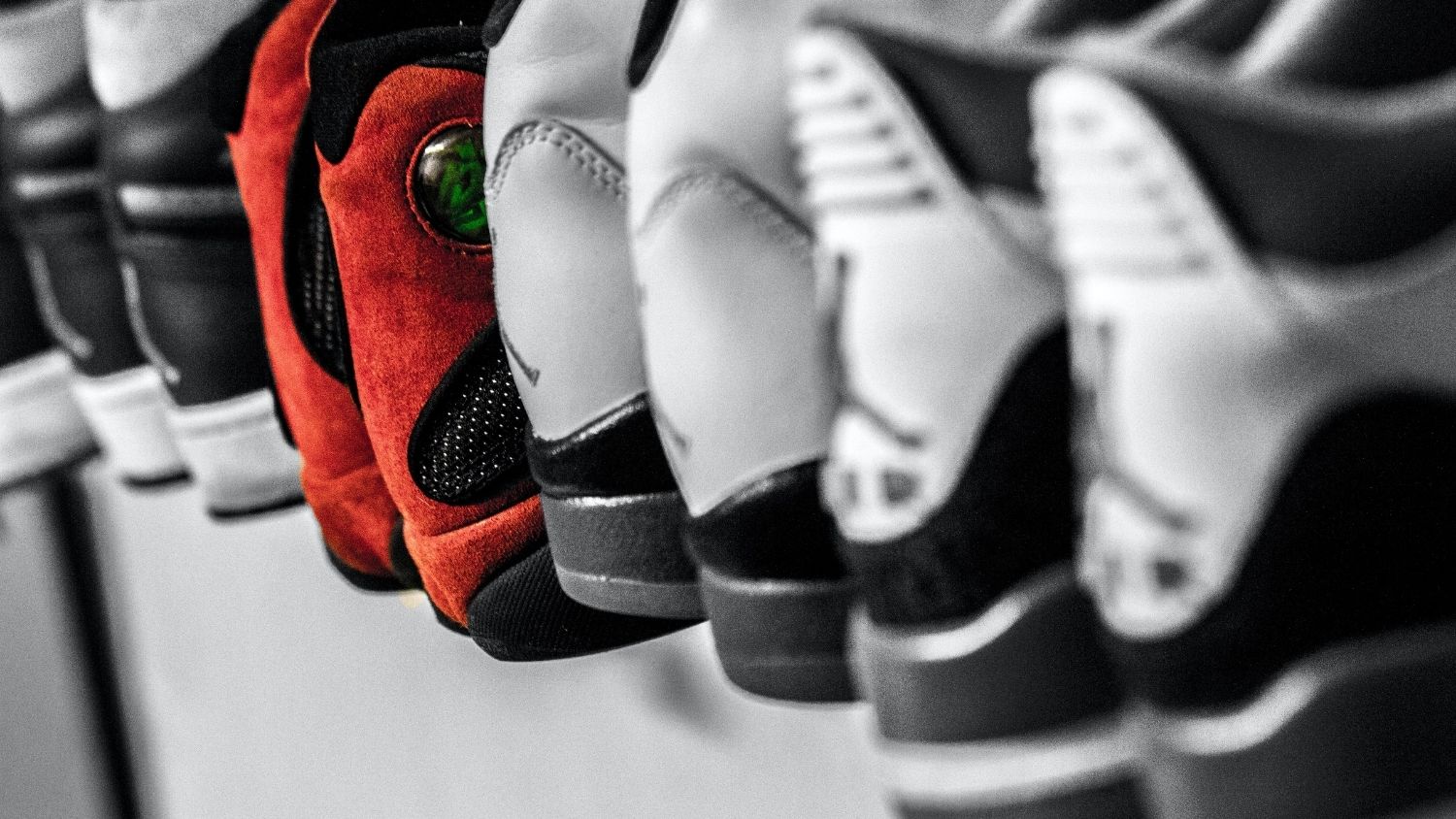 several pairs of red and white sneakers lined up